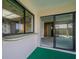 Enclosed patio features sliding glass doors, kitchen view through a large window, and outdoor access at 601 Riviera Bay Ne Dr, St Petersburg, FL 33702