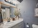 Bathroom featuring a natural wood-framed mirror over the vanity and neutral gray walls at 6262 142Nd N Ave # 1106, Clearwater, FL 33760