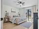 Light-filled bedroom with a plush bed, neutral decor, and a sliding glass door to the patio at 6262 142Nd N Ave # 1106, Clearwater, FL 33760