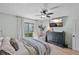 Bedroom with a large dresser and TV mounted on the wall, with ample natural light at 6262 142Nd N Ave # 1106, Clearwater, FL 33760
