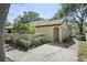 Charming exterior view of home featuring an arched entry and landscaped walkway to the front door at 6262 142Nd N Ave # 1106, Clearwater, FL 33760