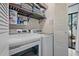 Well-organized laundry room with washer, dryer, storage shelves, and access to the backyard patio at 6262 142Nd N Ave # 1106, Clearwater, FL 33760
