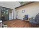 Charming outdoor patio with wooden tiles, furniture, string lights, and backyard access at 6262 142Nd N Ave # 1106, Clearwater, FL 33760