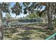 Community tennis court surrounded by lush greenery and mature trees at 6262 142Nd N Ave # 1106, Clearwater, FL 33760
