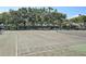 Outdoor tennis court area in the community with mature trees at 6262 142Nd N Ave # 1106, Clearwater, FL 33760