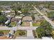 Aerial view of a neighborhood with homes, mature trees, and paved streets at 9100 2Nd N St, St Petersburg, FL 33702