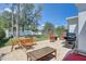 Spacious backyard with a paver patio, grill, outdoor seating, and mature trees at 9100 2Nd N St, St Petersburg, FL 33702