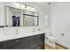 Bright bathroom featuring double sink vanity, modern fixtures, and access to walk-in closet at 9100 2Nd N St, St Petersburg, FL 33702