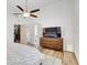 Comfortable bedroom boasts a ceiling fan, dresser, and a spacious closet for storage at 9100 2Nd N St, St Petersburg, FL 33702