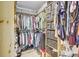 Walk-in closet with custom shelving and hanging rods for optimal organization and storage at 9100 2Nd N St, St Petersburg, FL 33702