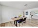 Bright dining room features a live edge wood table, black upholstered chairs and wood flooring at 9100 2Nd N St, St Petersburg, FL 33702