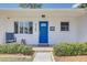 A close up on the front door with a beautiful blue finish and decorative glass at 9100 2Nd N St, St Petersburg, FL 33702