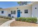 Nice single-story home with fresh exterior paint, neatly maintained landscaping, and a vibrant blue front door at 9100 2Nd N St, St Petersburg, FL 33702