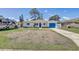 Single-story home featuring a well-manicured lawn, attached garage, and a parked RV; all beneath a bright, cloud-dotted sky at 9100 2Nd N St, St Petersburg, FL 33702