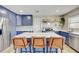 A stunning kitchen features stainless appliances, a large island with seating and a tiled backsplash at 9100 2Nd N St, St Petersburg, FL 33702