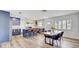 A stylish kitchen with stainless appliances, an island with seating and an adjacent dining area at 9100 2Nd N St, St Petersburg, FL 33702