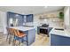 A modern kitchen with a large island, stainless steel appliances and blue cabinets at 9100 2Nd N St, St Petersburg, FL 33702