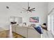 Spacious living room with wood floors, sectional sofa, and a large TV create a relaxing space at 9100 2Nd N St, St Petersburg, FL 33702