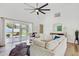 Inviting living room with vaulted ceiling, comfortable sectional, and seamless access to the outdoor patio at 9100 2Nd N St, St Petersburg, FL 33702