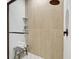 Stylish shower with vertical tile, glass door, and a built in bench at 9100 2Nd N St, St Petersburg, FL 33702