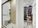 Shower with glass door and closet featuring built in shelving and clothing racks at 9100 2Nd N St, St Petersburg, FL 33702