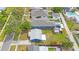 Aerial view of the home and backyard, showing the home's light gray roof, green lawn, and the neighborhood at 940 57Th N Ave, St Petersburg, FL 33703