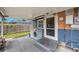 Covered back porch with laundry hookups, a door, and access to the backyard at 940 57Th N Ave, St Petersburg, FL 33703