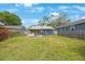 Large backyard area with a covered porch area attached to the house at 940 57Th N Ave, St Petersburg, FL 33703