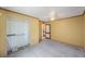 Carpeted bedroom with ceiling fan, open closet, and yellow walls at 940 57Th N Ave, St Petersburg, FL 33703