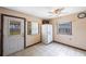 Eat-in kitchen featuring tile flooring, fan, double door refrigerator, and exterior access door at 940 57Th N Ave, St Petersburg, FL 33703