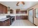 Kitchen featuring dark wood cabinets, stainless steel appliances, and tiled flooring at 940 57Th N Ave, St Petersburg, FL 33703
