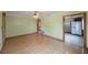 Bright living room with hardwood floors and an entry to the kitchen with white appliances at 940 57Th N Ave, St Petersburg, FL 33703