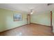 Bright living room with hardwood floors, a ceiling fan, and natural light from a window at 940 57Th N Ave, St Petersburg, FL 33703