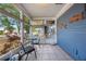 Enclosed porch with tiled floor and casual seating, offering a relaxing outdoor space at 940 57Th N Ave, St Petersburg, FL 33703