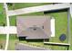 An overhead view shows a tan home's roof, fenced backyard, and manicured lawn within a suburban neighborhood setting at 9617 Branching Ship Trce, Wesley Chapel, FL 33545