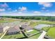Aerial view of a backyard in a vibrant neighborhood with ponds and green spaces, showcasing community and natural beauty at 9617 Branching Ship Trce, Wesley Chapel, FL 33545