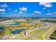 This aerial view showcases the home and community, dotted with lakes and lush greenery at 9617 Branching Ship Trce, Wesley Chapel, FL 33545