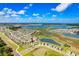 This aerial view showcases the home and community, dotted with lakes and lush greenery at 9617 Branching Ship Trce, Wesley Chapel, FL 33545