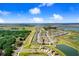 This aerial view showcases the home and community, dotted with lakes and lush greenery at 9617 Branching Ship Trce, Wesley Chapel, FL 33545
