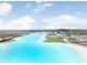 Stunning aerial view of a crystal-clear lagoon, resort-style amenities, and surrounding landscape at 9617 Branching Ship Trce, Wesley Chapel, FL 33545