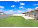 Large backyard features green grass, a trampoline and a white fence at 9617 Branching Ship Trce, Wesley Chapel, FL 33545