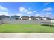 Spacious backyard with green lawn, white fence, and trampoline at 9617 Branching Ship Trce, Wesley Chapel, FL 33545