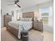 Inviting bedroom with a ceiling fan, neutral tones, and large windows for natural light at 9617 Branching Ship Trce, Wesley Chapel, FL 33545