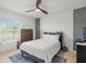Comfortable bedroom featuring a queen bed, modern decor, and a ceiling fan at 9617 Branching Ship Trce, Wesley Chapel, FL 33545