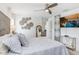 Bedroom features an entertainment center and decorative wall art at 9617 Branching Ship Trce, Wesley Chapel, FL 33545