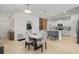 Bright dining area features stylish chairs, marble table, and seamless flow into the modern kitchen at 9617 Branching Ship Trce, Wesley Chapel, FL 33545
