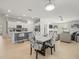 Open concept dining area flows into the kitchen and living room with natural light creating an airy space at 9617 Branching Ship Trce, Wesley Chapel, FL 33545