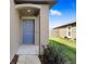 Charming front porch with blue door and manicured landscaping at 9617 Branching Ship Trce, Wesley Chapel, FL 33545