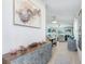 Inviting hallway with decorative cabinet and a view into the dining and living areas at 9617 Branching Ship Trce, Wesley Chapel, FL 33545