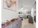 Open hallway with modern decor leading to the living room and dining area at 9617 Branching Ship Trce, Wesley Chapel, FL 33545